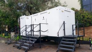 luxury porta potty trailer next to a building