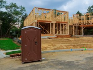 porta potty next to a new construction home